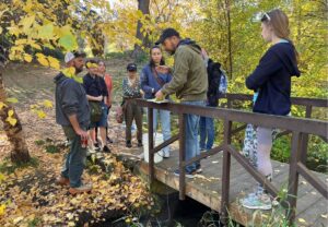 EWU geologist Chad Pritchard (on bridge) with students sampling Garden Springs creek in Spokane’s Finch Arboretum in autumn of 2024. The creek is fed with spring water originating near the Spokane International Airport. The sampling revealed levels of PFAS (Per-and Polyfluoroalkyl) chemicals in the creek well in excess of federal drinking water standards